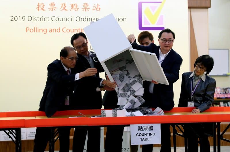 Officials open a ballot box at a polling station in Kowloon Tong, Hong Kong