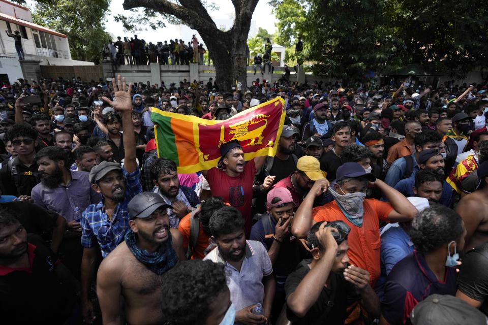 Sri Lankan protesters storm the compound of prime minister Ranil Wickremesinghe 's office, demanding he resign after president Gotabaya Rajapaksa fled the country amid economic crisis in Colombo, Sri Lanka, Wednesday, July 13, 2022. (AP Photo/Eranga Jayawardena)