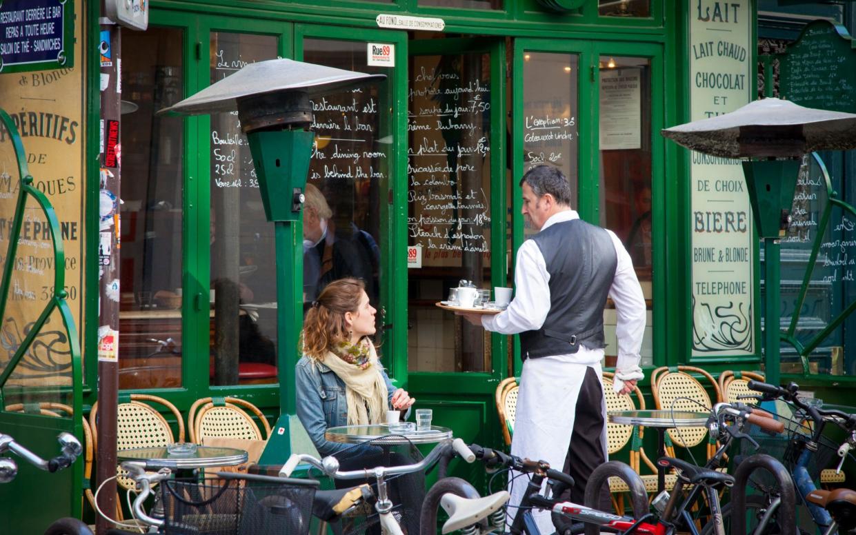 Waiter and customer at a café