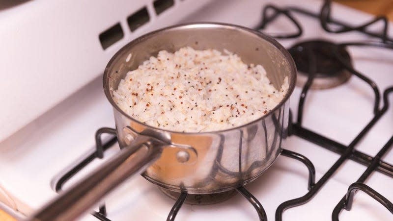 Pan of rice cooking on gas stovetop