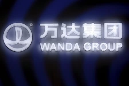 A sign of Dalian Wanda Group in China glows during an event announcing strategic partnership between Wanda Group and FIFA in Beijing, China March 21, 2016. REUTERS/Damir Sagolj Picture Supplied by Action Images