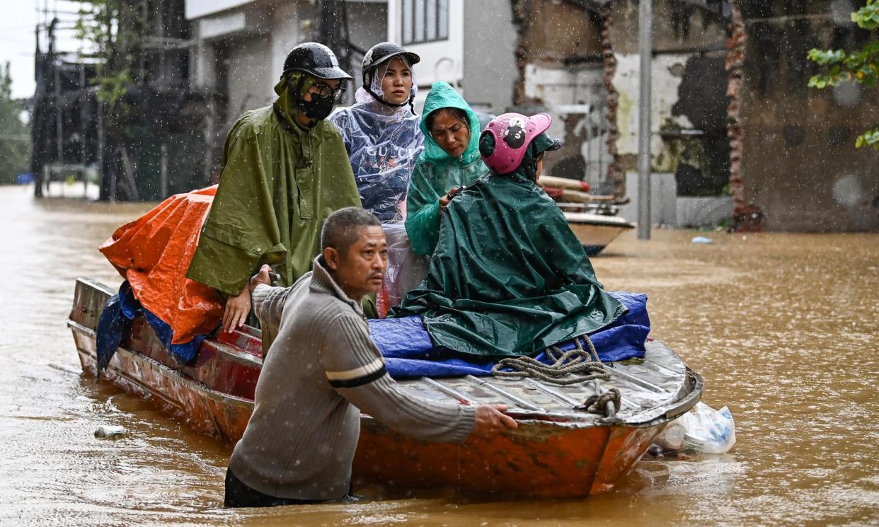 <span>Local residents are evacuated on a boat through flood waters caused by Typhoon Yagi in Hanoi on Wednesday. </span><span>Photograph: Nhac Nguyen/AFP/Getty Images</span>