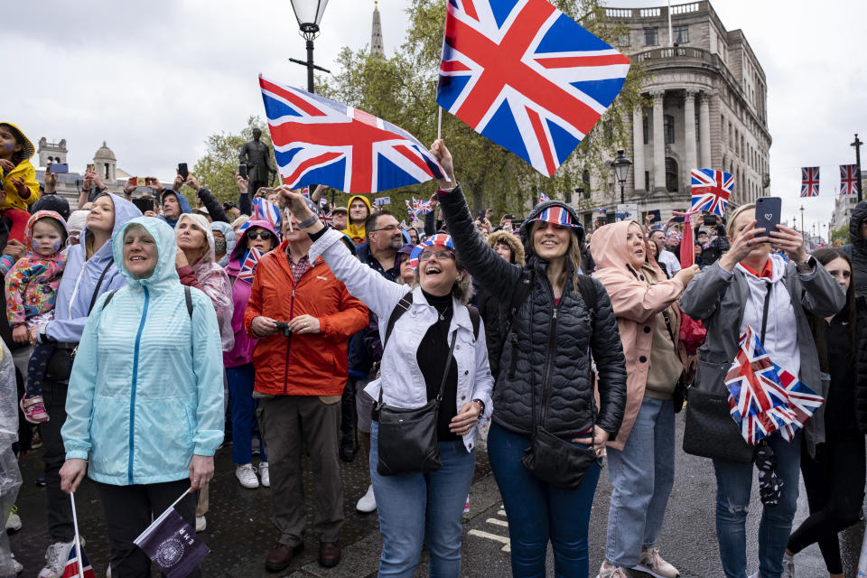 Crowds of people gather in the rain in central London to witness the Coronation of King Charles III on 6th May 2023 in London, United Kingdom. Despite people not being able to get close to see, royalists and royal fans gathered waving flags and wearing red white and blue of the Union flag in celebration as King Charles III was crowned King of England. (photo by Mike Kemp/In Pictures via Getty Images)