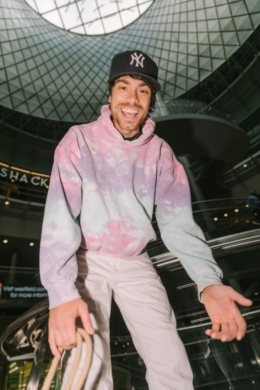 YouTuber Caleb Simpson in pink sweatshirt