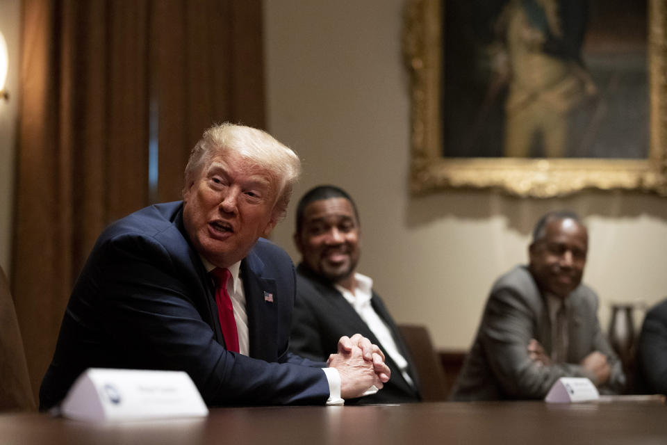 President Donald Trump speaks during a roundtable discussion with African-American supporters in the Cabinet Room of the White House, Wednesday, June 10, 2020, in Washington. Seated alongside Trump are Pastor Darrell Scott and Housing and Urban Development Secretary Ben Carson. (AP Photo/Patrick Semansky)