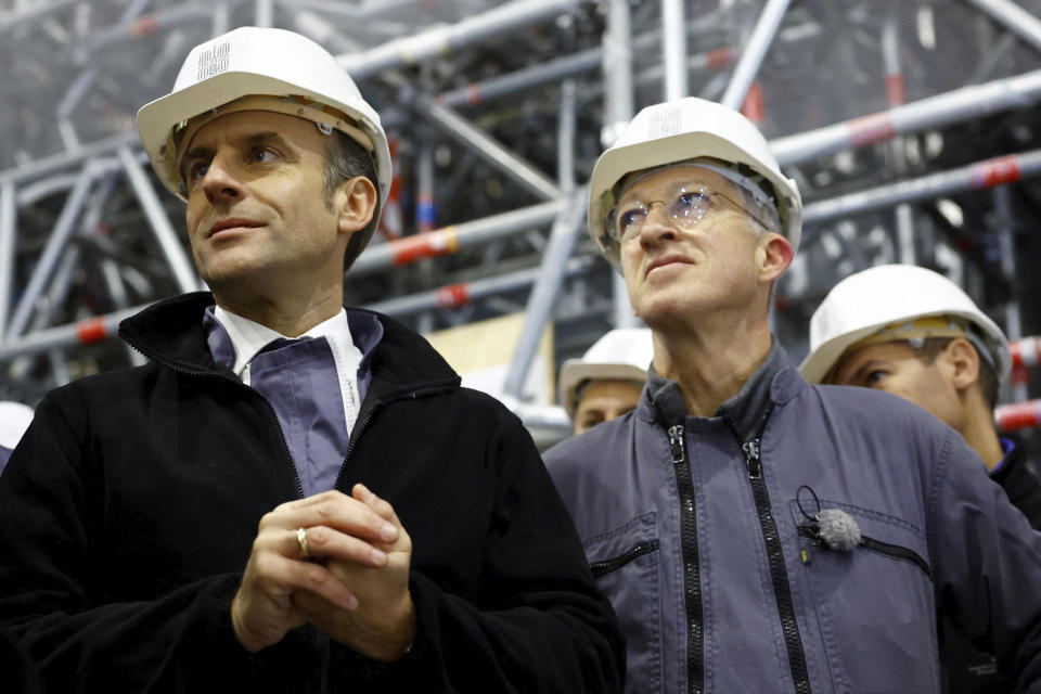 French President Emmanuel Macron, left, and Philippe Jost, President of the public establishment "Rebuilding Notre-Dame de Paris" visit the nave of Notre Dame de Paris cathedral, Friday, Dec. 8, 2023 in Paris. Emmanuel Macron is visiting Notre Dame Cathedral on Friday, marking the one-year countdown to its reopening in 2024 following extensive restoration after the fire four years ago. (Sarah Meyssonnier, Pool via AP)