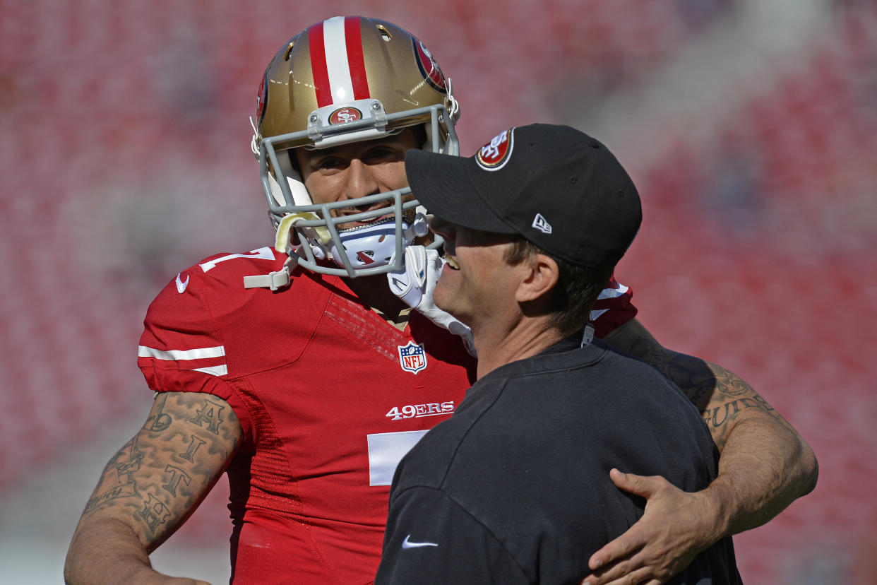 While he was coaching the San Francisco 49ers, Jim Harbaugh (right) coached Colin Kaepernick to a Super Bowl. The two have maintained a strong relationship since then. (JOSE CARLOS FAJARDO/MediaNews Group/Bay Area News via Getty Images)