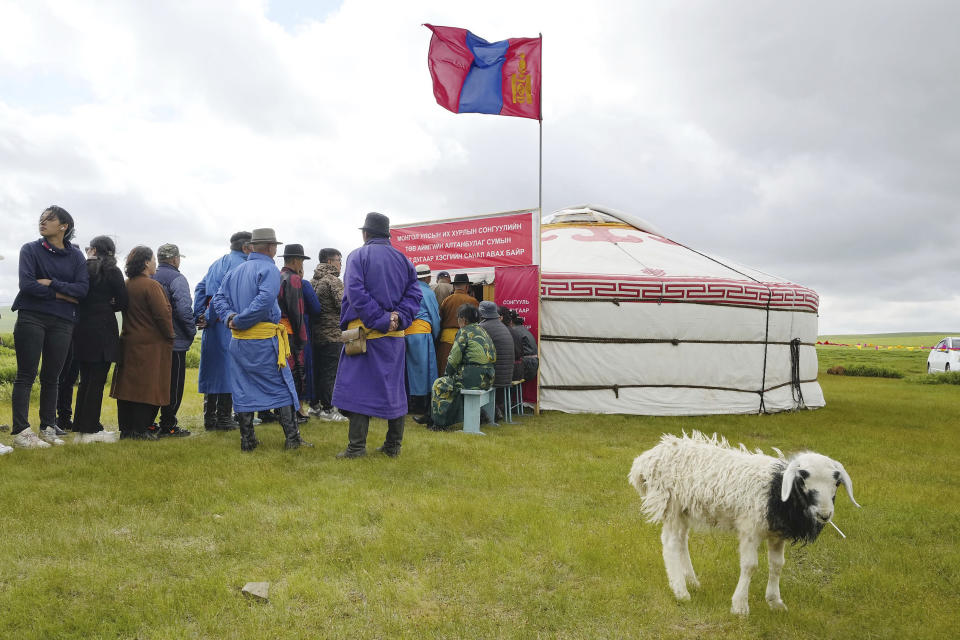 People wait in line for voting at a makeshift polling station inside a ger in Tuv province, Mongolia Friday, June 28, 2024. Voters in the relatively young democracy of Mongolia were electing a new parliament on Friday in their landlocked country squeezed between China and Russia, two much larger authoritarian states. (Ken Ishii/Kyodo News via AP)