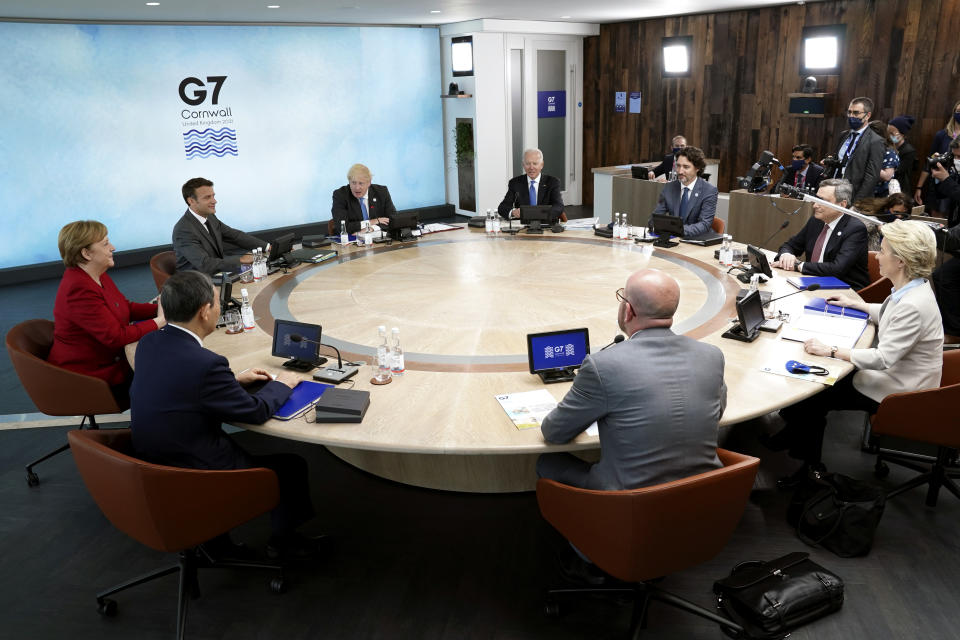 Clockwise from left, German Chancellor Angela Merkel and French President Emmanuel Macron, British Prime Minister Boris Johnson, U.S. President Joe Biden, Canadian Prime Minister Justin Trudeau, Italy's Prime Minister Mario Draghi, European Commission President Ursula von der Leyen, European Council President Charles Michel, and Japan's Prime Minister Yoshihide Suga sit around a table during the G-7 summit at the Carbis Bay Hotel in Carbis Bay, St. Ives, Cornwall, England, Friday, June 11, 2021. Leaders of the G-7 begin their first of three days of meetings on Friday, in which they will discuss COVID-19, climate, foreign policy and the economy. (Kevin Lamarque/Pool via AP)