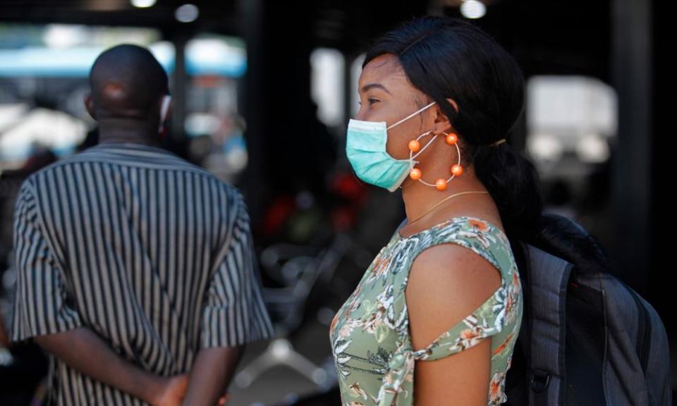 A woman queues to enter a shop in Lagos, the city at the centre of the coronavirus outbreak in Nigeria.