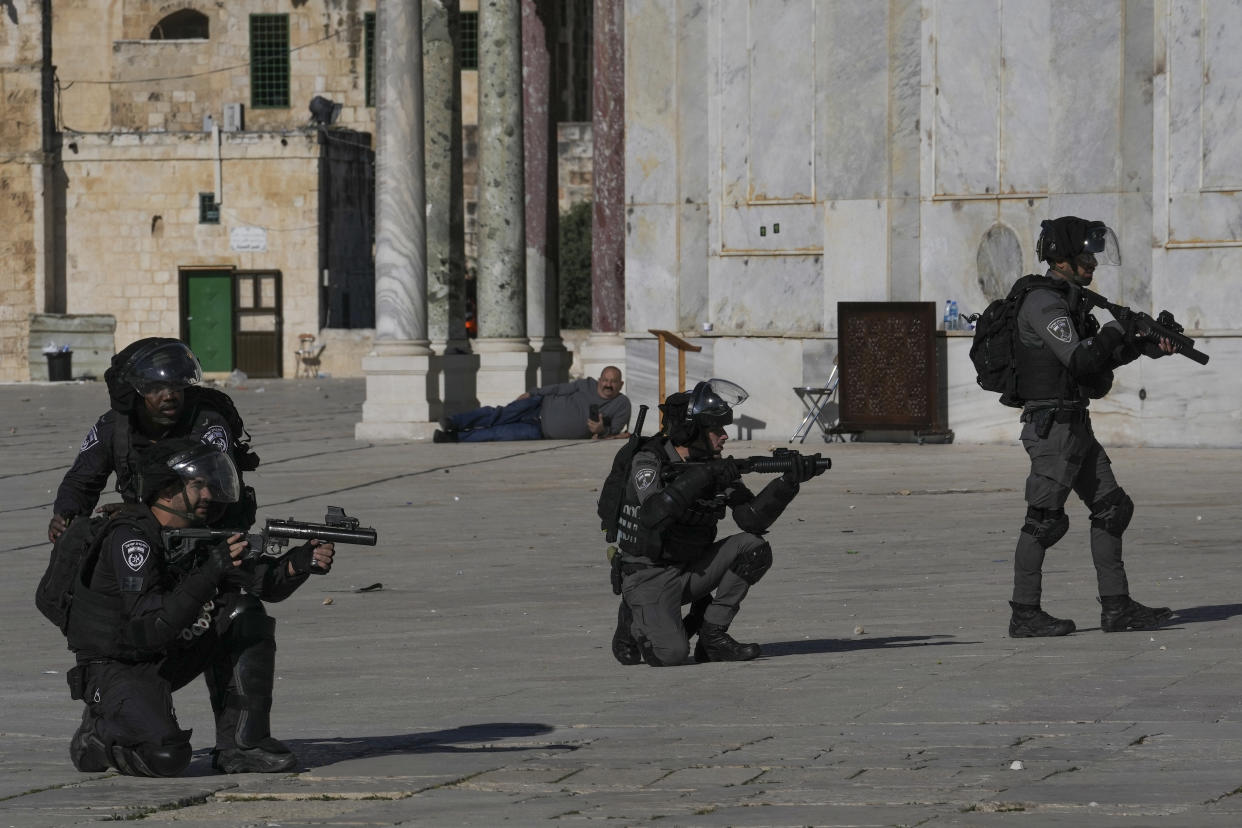 Israeli security forces take position during clashes with Palestinians demonstrators at the Al Aqsa Mosque compound in Jerusalem's Old City, Friday, April 15, 2022. (AP Photo/Mahmoud Illean)