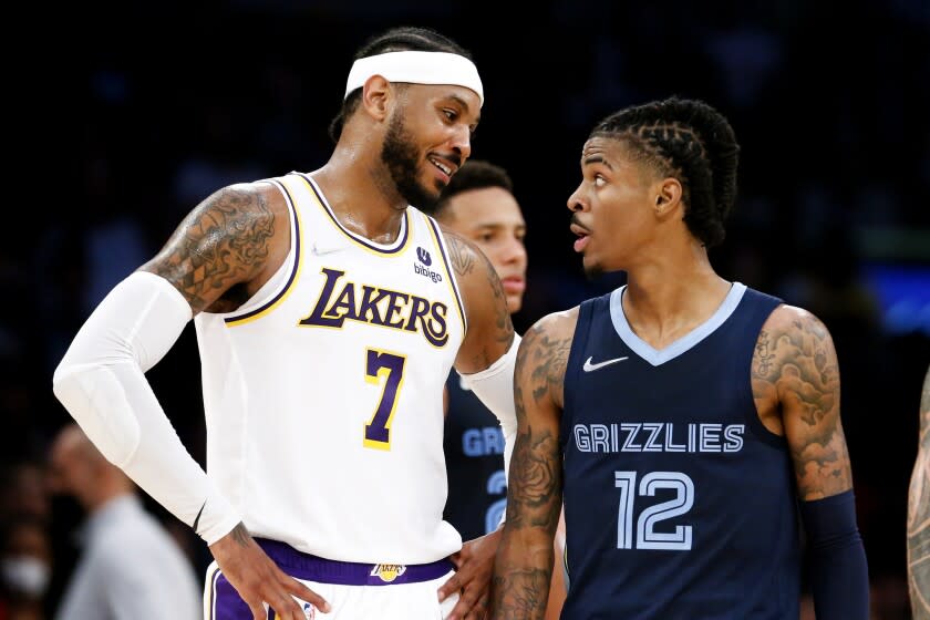 Los Angeles Lakers forward Carmelo Anthony (7) talks with Memphis Grizzlies guard Ja Morant.