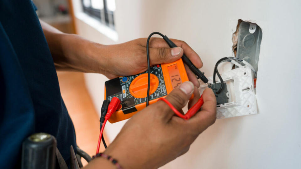 hands inspecting electrical wiring