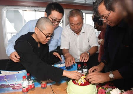 Liu Xia, wife of deceased Chinese Nobel Peace Prize-winning dissident Liu Xiaobo and other relatives attend his sea burial off the coast of Dalian, China in this photo released by Shenyang Municipal Information Office on July 15, 2017. Shenyang Municipal Information Office/via REUTERS