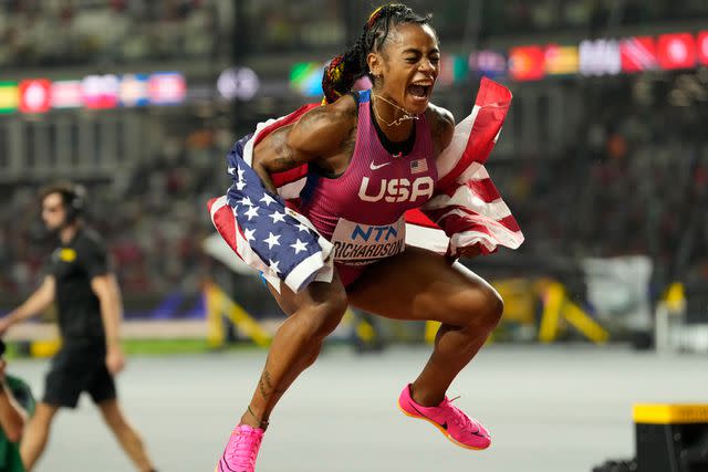 <p>AP Photo/Ashley Landis</p> Sha'Carri Richardson celebrates her gold medal win during the 2023 World Athletics Championships