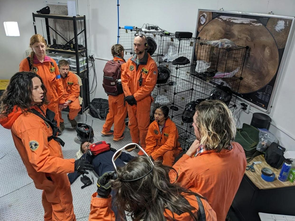 Space medicine professionals in training consult with each other during a simulation exercise. Katya Arquilla