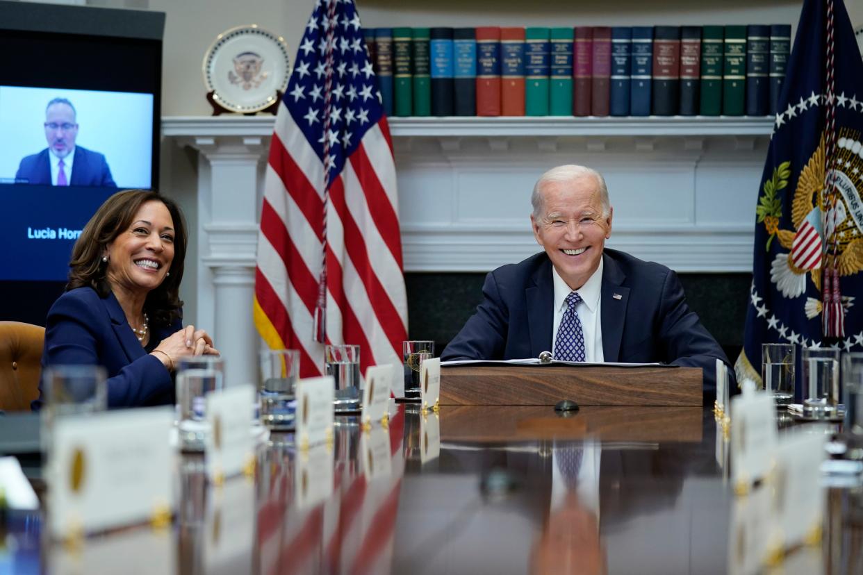 President Joe Biden and Vice President Kamala Harris smile during a meeting with his "Investing in America Cabinet," in the Roosevelt Room of the White House, Friday, May 5, 2023, in Washington. Education Secretary Miguel Cardona appears on a screen as he attends the meeting virtually. (AP Photo/Evan Vucci) ORG XMIT: DCEV420
