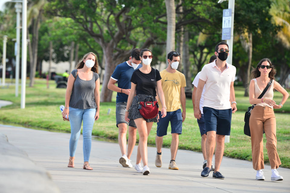 MIAMI BEACH, FL - JULY 06: People seen walking on the beach side walk some wearing mask and some not wearing a face mask on July 06, 2020 in Miami Beach, Florida. Miami Beach has mandated that masks be worn in public, where social distancing is not possible. With a surge in COVID-19 cases, Mayor Carlos Gimenez on Monday has ordered the closing of all restaurants, gyms and fitness centers, ballrooms and short-term vacation rentals. Mayor Gimenez will allow beaches to re-open on July 7th after being closed over the 4th of July weekend. (Photo by Johnny Louis/Getty Images)