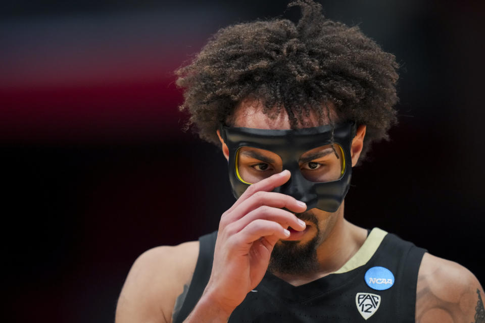 Colorado guard J'Vonne Hadley adjusts his mask during the first half of a First Four game in the NCAA men's college basketball tournament against Boise State, Wednesday, March 20, 2024, in Dayton, Ohio. (AP Photo/Aaron Doster)