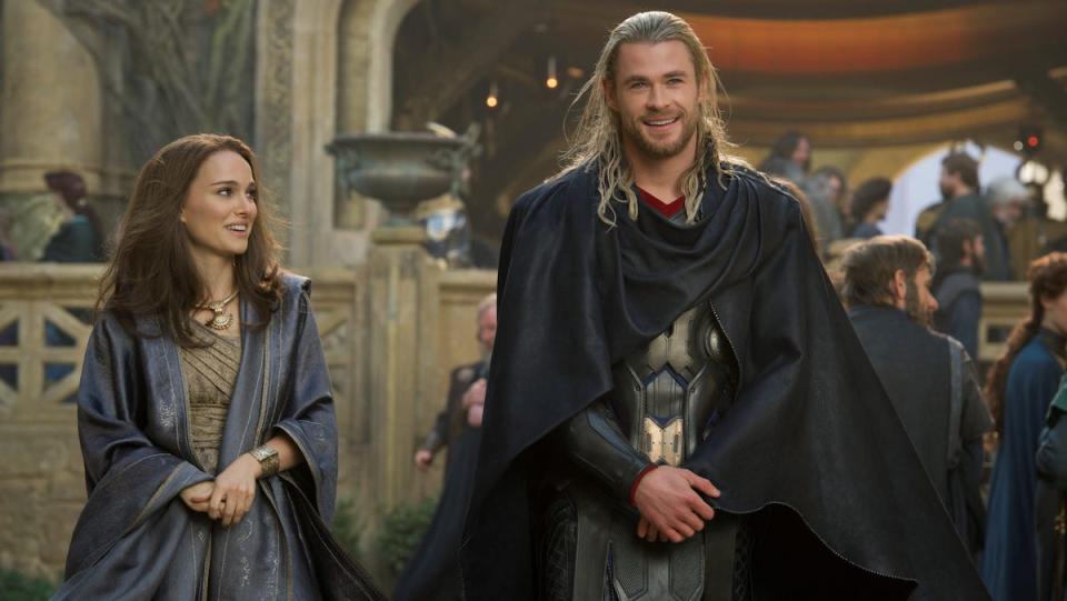 Thor sits next to Jane in his Asgardian castle.