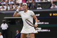 Tunisia's Ons Jabeur celebrates winning the second set against Aryna Sabalenka of Belarus in a women's singles semifinal match on day eleven of the Wimbledon tennis championships in London, Thursday, July 13, 2023. (AP Photo/Alberto Pezzali)