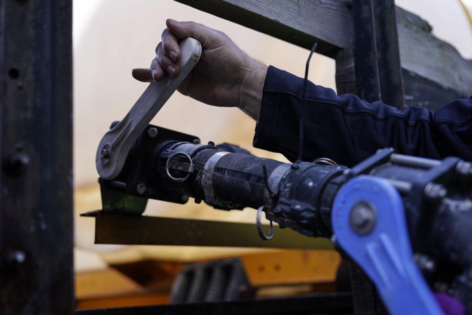 A Georgia Department of Transportation response member pulls a lever on a brine truck ahead of a winter storm at the GDOT's Maintenance Activities Unit location on Friday, Jan. 14, 2022, in Forest Park, Ga. A winter storm is headed south that could effect much of Georgia through Sunday. (AP Photo/Brynn Anderson)