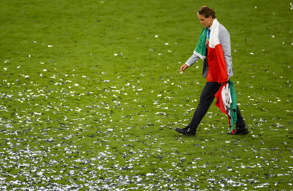 FILE - Italy's manager Roberto Mancini walks on the pitch after defeating England at the Euro 2020 soccer championship final at Wembley stadium in London, Sunday, July 11, 2021. Italy coach Roberto Mancini resigned surprisingly on Sunday, Aug. 13, 2023, ending an an up-and-down tenure with the national team that included a European Championship title in 2021 but also a failed qualification for last year’s World Cup. (John Sibley/Pool Photo via AP, File)