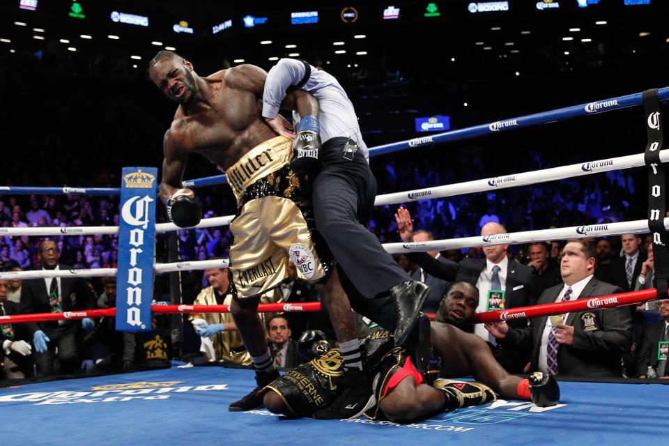 WBC heavyweight champion Deontay Wilder, shown knocking out Bermane Stiverne in November, is confident a bout with IBF-WBA champion Anthony Joshua will occur in 2018. (Getty Images)