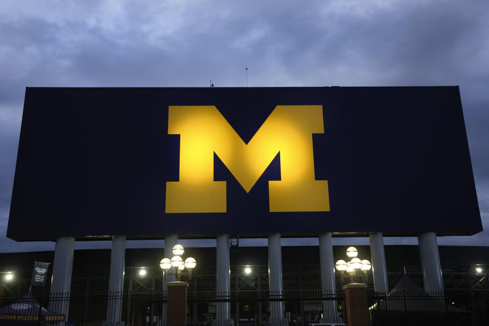 FILE - The block M logo for the University of Michigan is displayed at the school's NCAA college football stadium in Ann Arbor, Mich., Friday, Nov. 10, 2023. A Michigan judge who champions peacemaking principles in court will preside over a hearing on Friday, Nov. 17, that will determine whether Jim Harbaugh can coach and close the regular season on the field with the third-ranked Wolverines. Attorneys for Harbaugh and the university are asking Judge Timothy P. Connors to at least temporarily lift the Big Ten’s penalty against him for a sign-stealing scheme. (AP Photo/Paul Sancya, File)