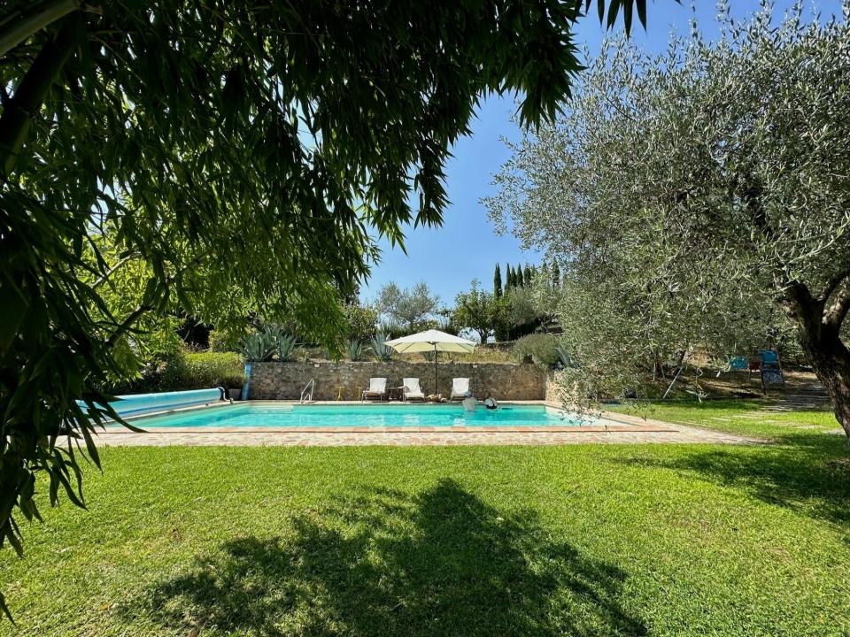 A pool in a yard on an Italian villa.