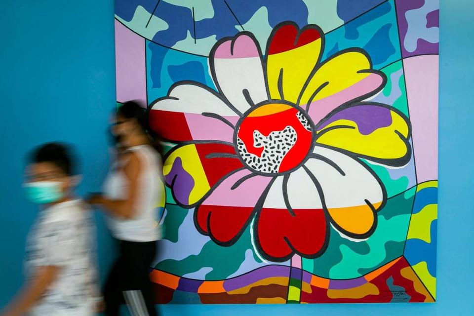 Visitors walk past Graffiti Pop Artist Jozza’s artwork “The Daisy” near Daniella’s Atrium on the fourth floor of Joe DiMaggio Children’s Hospital in Hollywood, Florida, on Friday, June 18, 2021. Jozza donated two of his artworks to the hospital Friday.