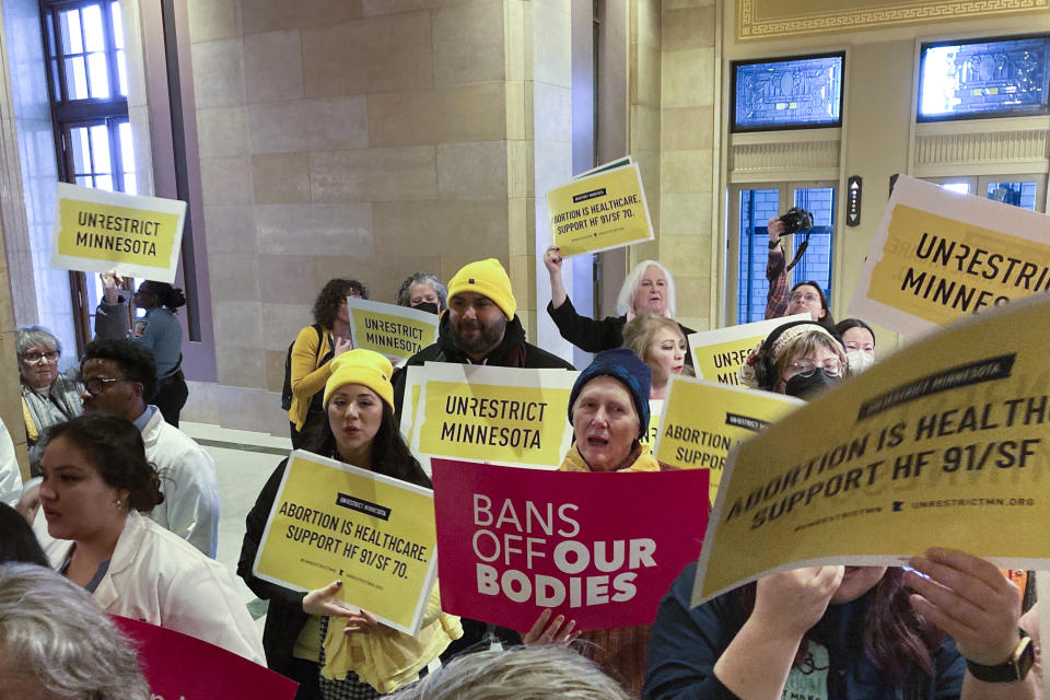 Abortion protesters on both sides pack the halls outside the Minnesota Senate chamber on Friday, Jan. 27, 2023, at the State Capitol in St. Paul, Minn. The Minnesota Senate is debating a bill Friday to write broad protections for abortion rights into state statutes, which would make it difficult for future courts to roll back. (AP Photo/Steve Karnowski)