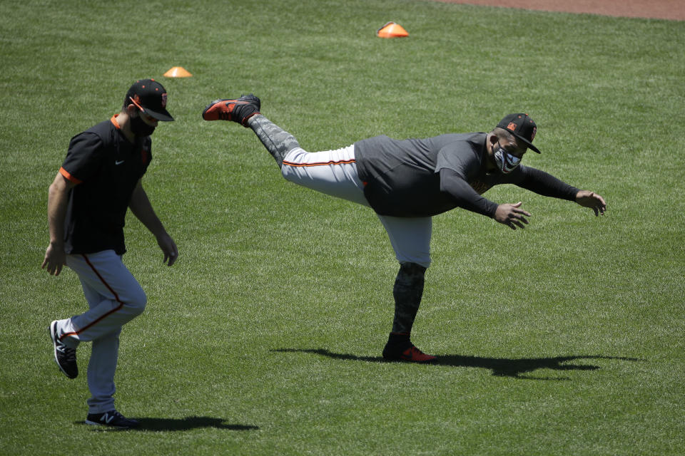 San Francisco Giants' Pablo Sandoval, right, stretches on the field during a baseball practice in San Francisco, Sunday, July 5, 2020. (AP Photo/Jeff Chiu)