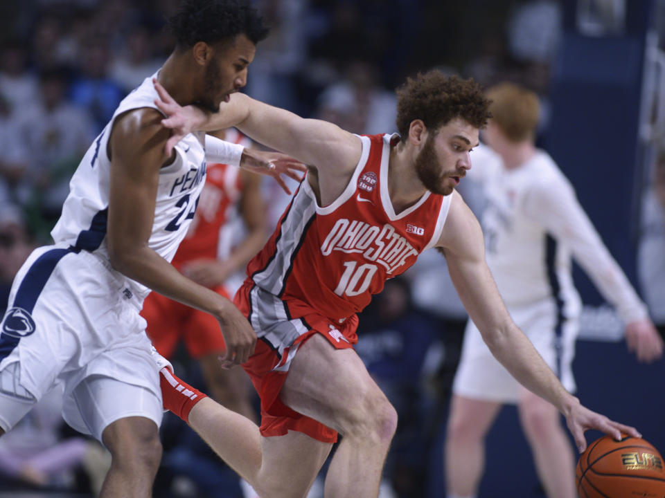 Penn State's Zach Hicks (24) and Ohio State's Jamison Battle (10) go after the ball during the first half of an NCAA college basketball game Saturday, Dec. 9, 2023, in State College, Pa. (AP Photo/Gary M. Baranec)