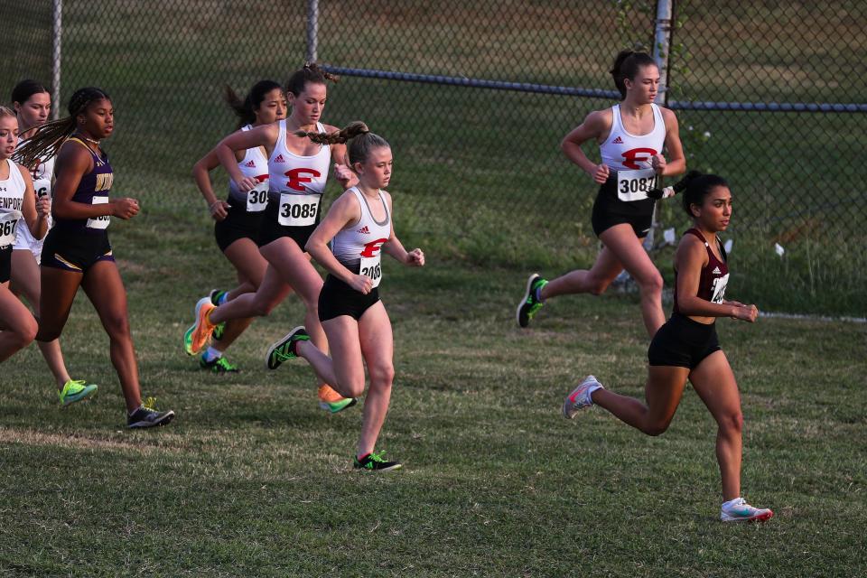 Sinton's Zerah Martinez, right, leads the pack out of the starting stretch at the UIL Region IV Cross Country Championships at Dr. Jack Dugan Family Soccer and Track Stadium in Corpus Christi, Texas on Monday, Oct. 24, 2022. Martinez won the 4A girls race with a time of 11:26.89.