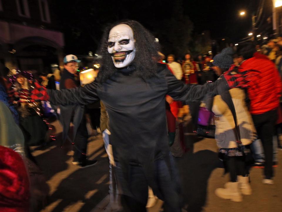 People in costume try to capture the attention of onlookers during the annual Portsmouth Halloween Parade Oct. 31, 2023.