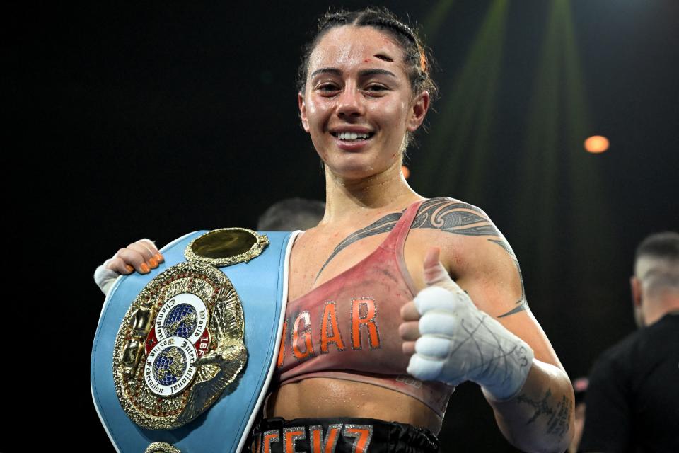 Seen here, New Zealand-born Australian boxer Cherneka Johnson poses with her belt after defending her IBF super-bantamweight world title against fellow Aussie Susie Ramadan. 