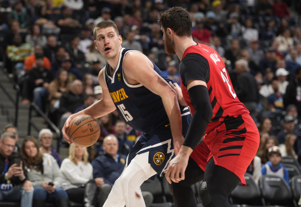 Denver Nuggets center Nikola Jokic, left, is defended by Portland Trail Blazers center Jusuf Nurkic during the second half of an NBA basketball game Tuesday, Jan. 17, 2023, in Denver. (AP Photo/David Zalubowski)