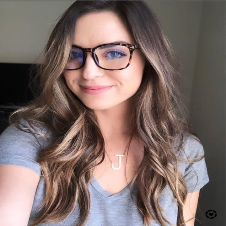 A reviewer wearing the blue light glasses in leopard