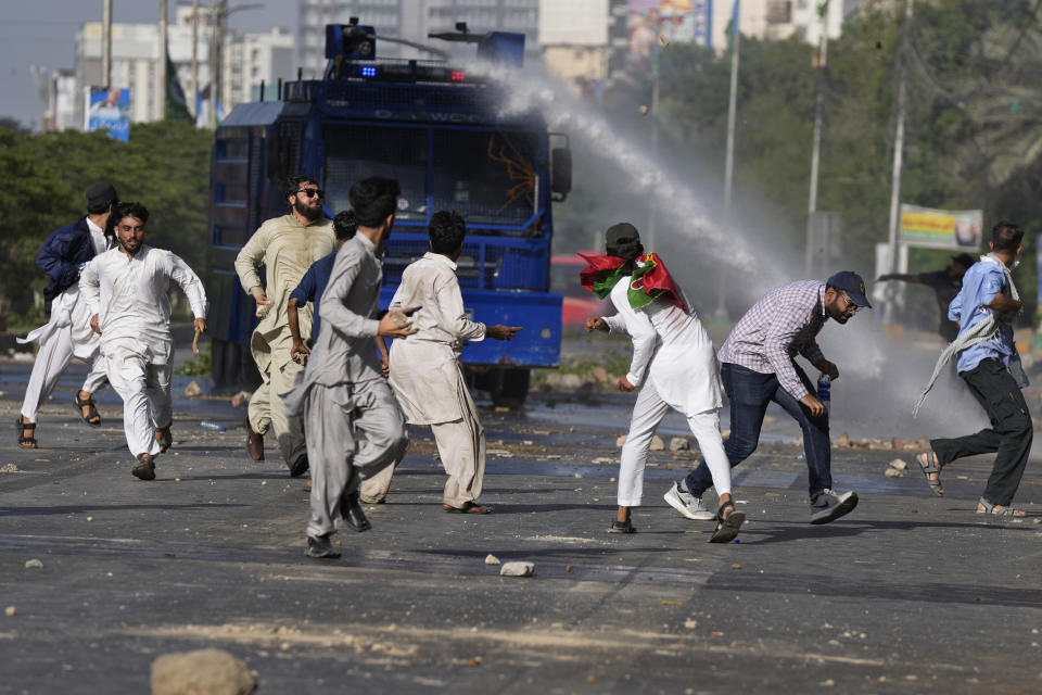 Police use a water cannon to disperse supporters of Pakistan's former Prime Minister Imran Khan protesting against the arrest of their leader, in Karachi, Pakistan, Tuesday, May 9, 2023. Khan was arrested Tuesday as he appeared in a court in the country’s capital, Islamabad, to face charges in multiple graft cases. Security agents dragged Khan outside and shoved him into an armored car before whisking him away. (AP Photo/Fareed Khan)