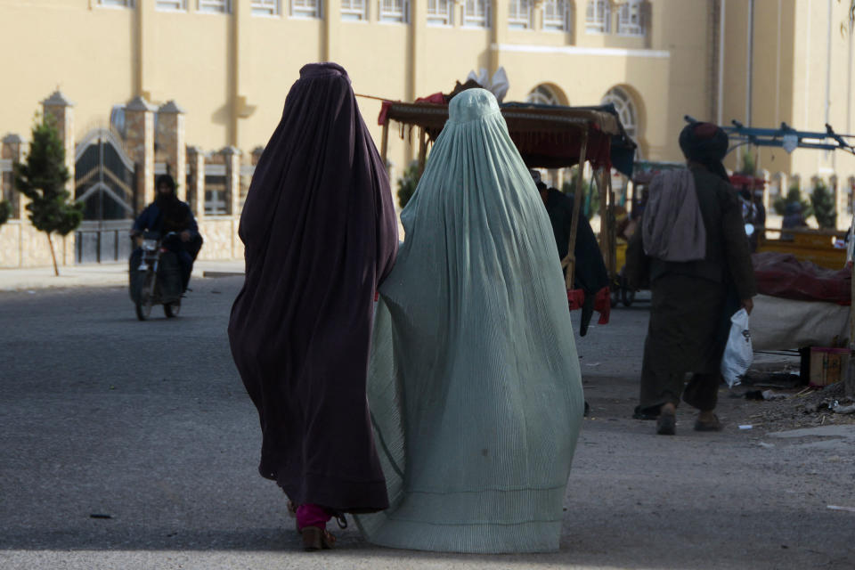 Burqa-clad women walk along a street in Kandahar on May 7, 2022.<span class="copyright">Javed Tanveer—AFP/Getty Images</span>