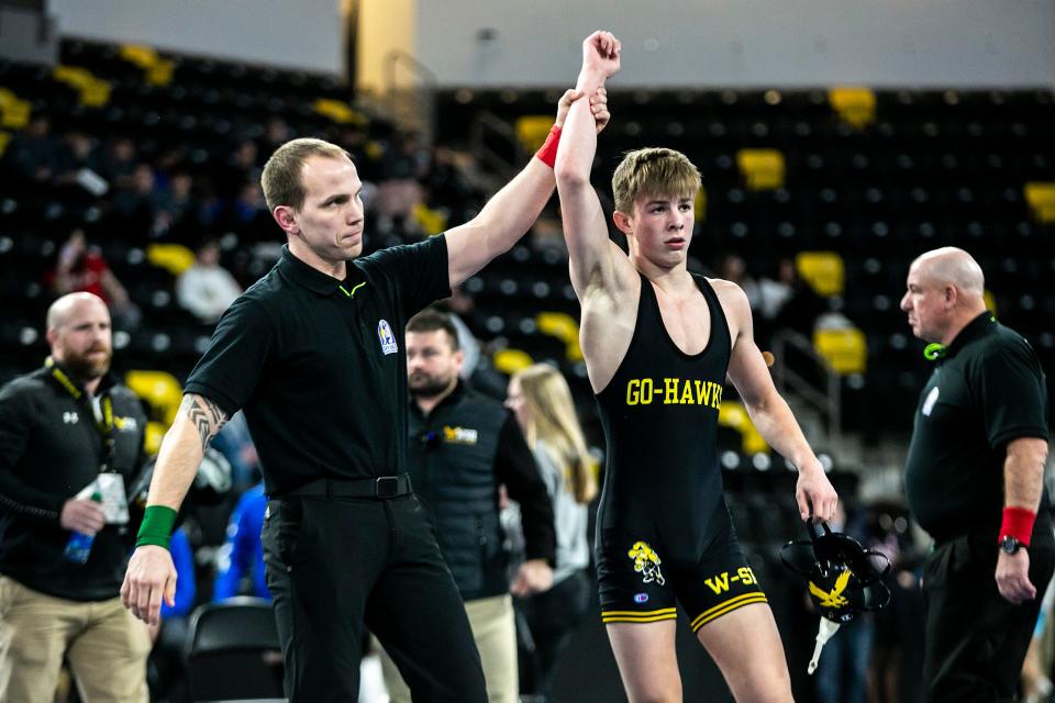 Waverly-Shell Rock's Ryder Block, right, has his hand raised after his match at 138 pounds during the finals of the Dan Gable Donnybrook high school wrestling tournament on Saturday at the Xtream Arena in Coralville, Iowa.