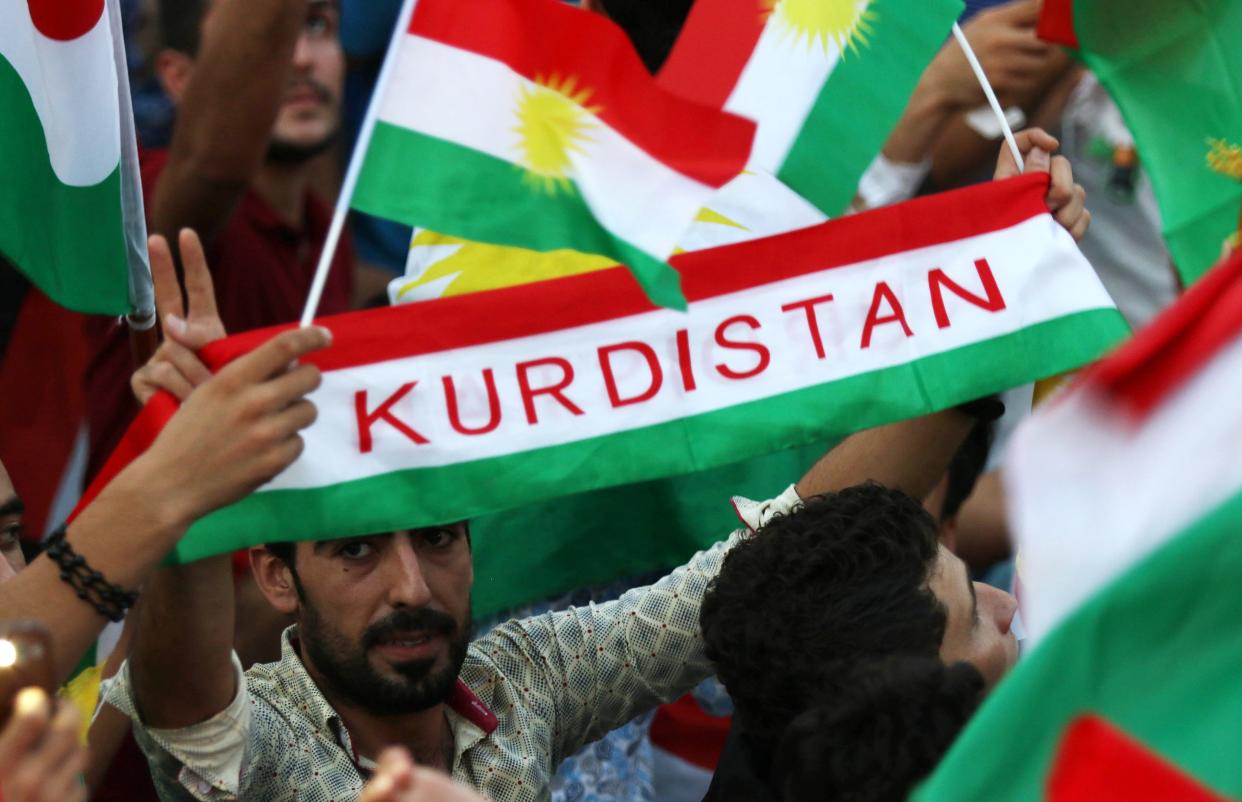 Iraqi Kurds fly Kurdish flags 