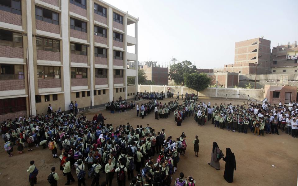 Students line up on the first day of their new school year at a government school in Giza