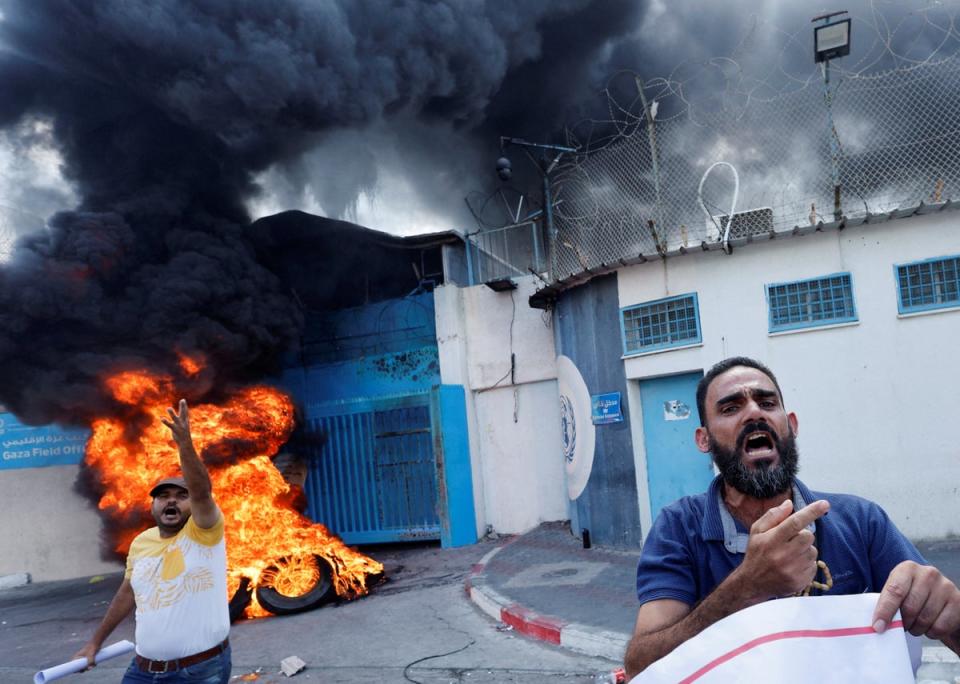 19 September 2022: People burn tires outside the headquarters of the United Nations Works and Relief Agency during a protest demanding them to rebuild their houses that were destroyed during the Israel-Gaza fighting in 2014, in Gaza City (Reuters)