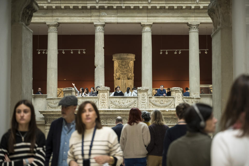 Visitors at Pergamon Museum in Berlin, Tuesday, April 4, 2023. A new light and sound installation by British contemporary artist Liam Gillick, part of the show Filtered Time, opened Tuesday at one of the German capital's most popular museums. (AP Photo/Stefanie Loos)