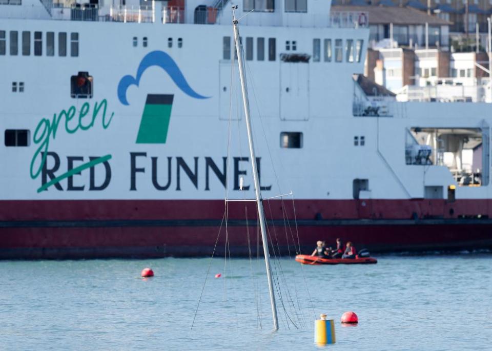 The ferry passes the mast of a submerged yacht.