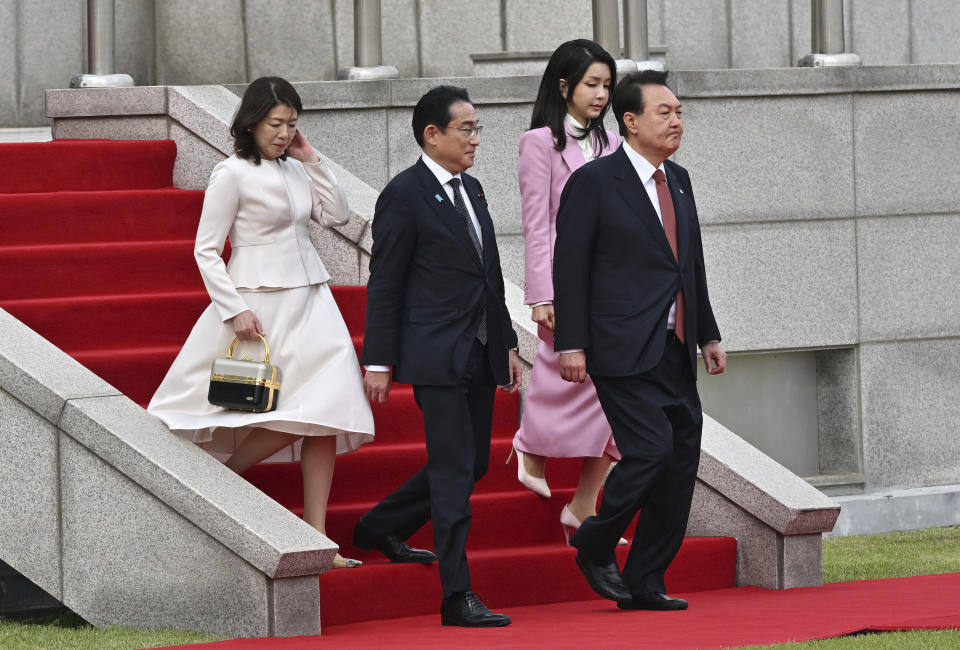 Japanese Prime Minister Fumio Kishida, second left, and his wife Yuko Kishida, left, attend with South Korean President Yoon Suk Yeol and his wife Kim Keon Hee during a welcoming ceremony at the presidential office in Seoul Sunday, May 7, 2023. (Jung Yeon-je/Pool Photo via AP)