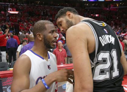Chris Paul and Tim Duncan share a moment. (Stephen Dunn/Getty Images)