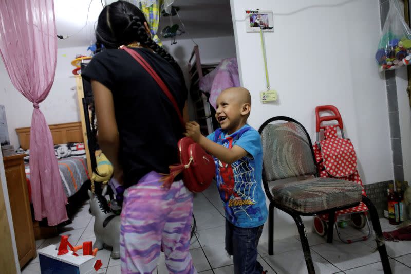 Hermes Soto plays with his sister Africa Soto at their house in Mexico City